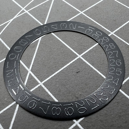 Grey date wheel for NH35 NH36 watch movement, black background, precise date display component.