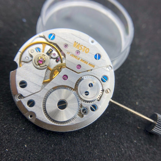 Close-up of Swiss Made ETA7001 mechanical movement watch repair part for precise timekeeping.