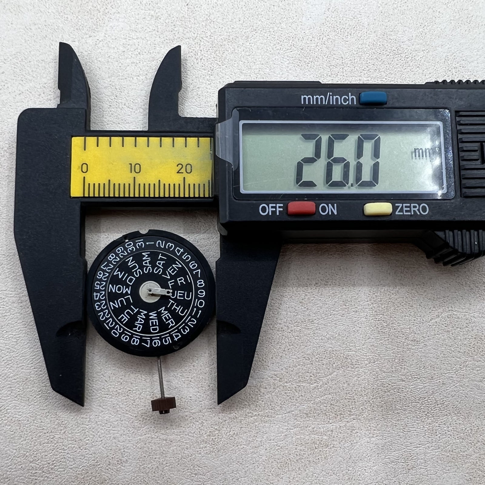 Swiss Ronda 517 quartz movement watch with dual calendar, three hands, and sleek black dial.