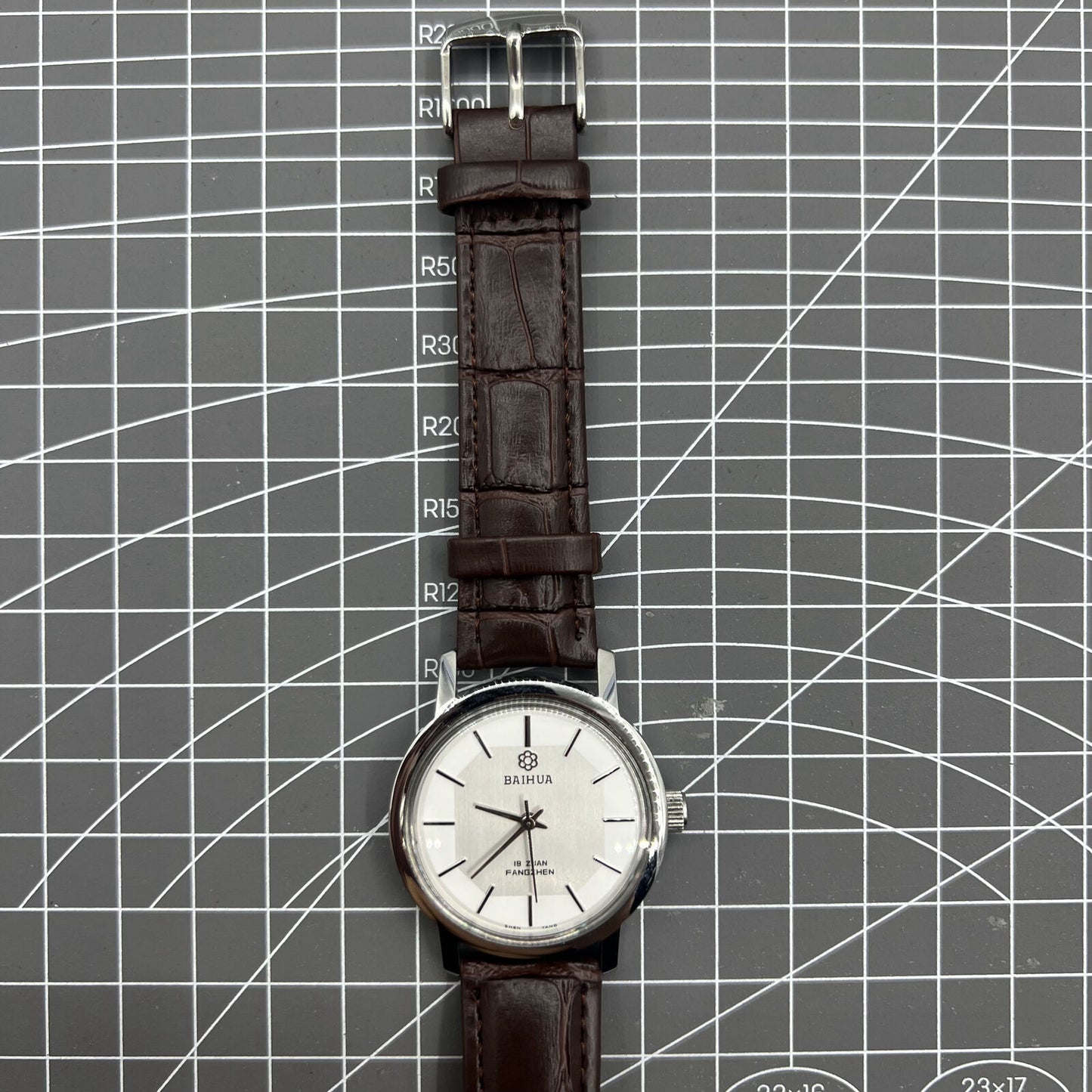 China Baihua 37mm manual mechanical watch with silver dial, 19 jewels, and shock-resistant design.