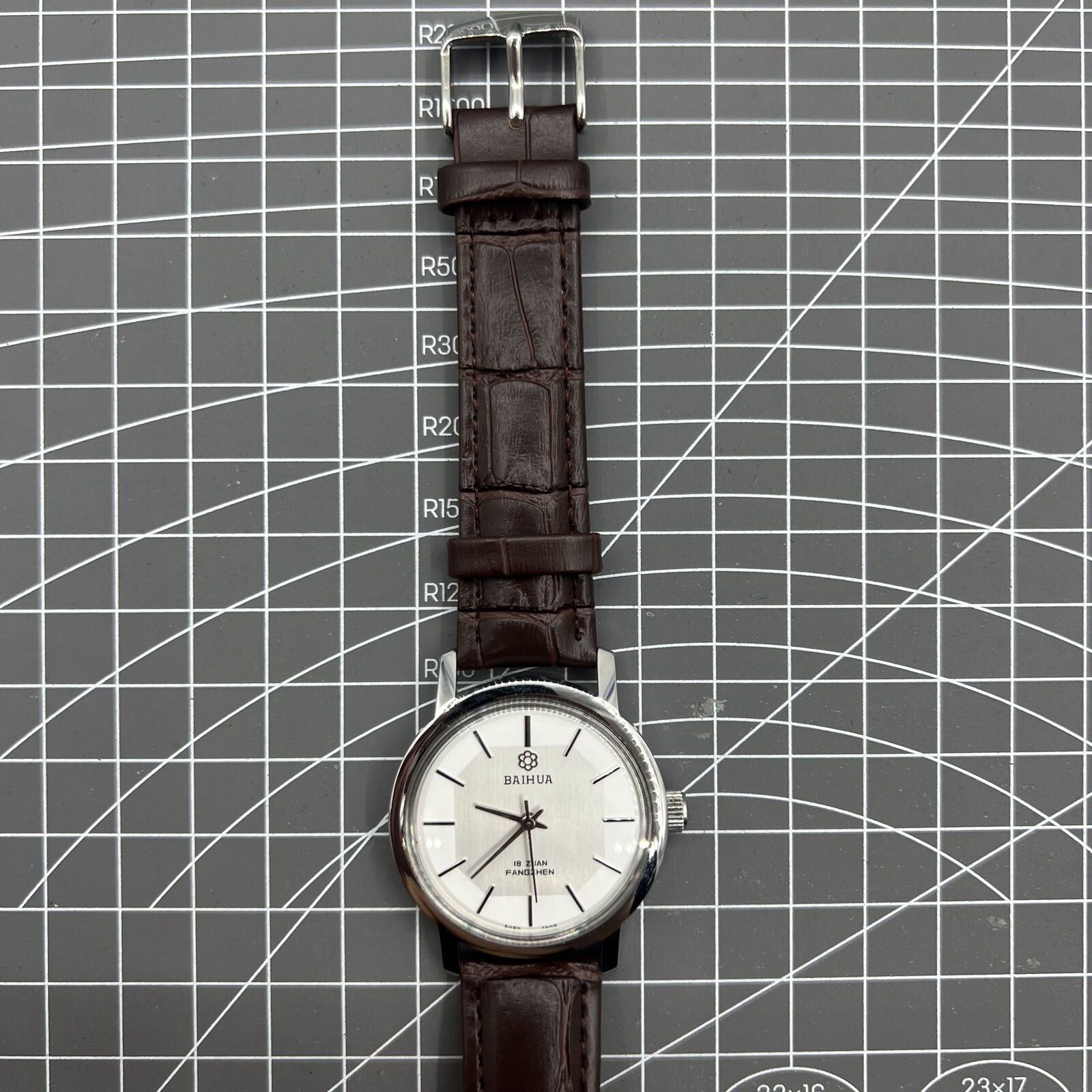 China Baihua 37mm manual mechanical watch with silver dial, 19 jewels, and shock-resistant design.