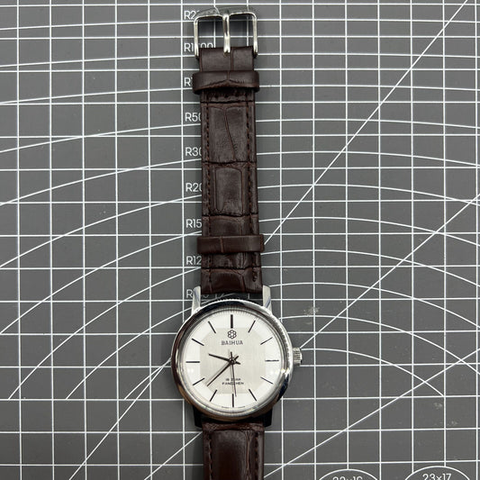 China Baihua 37mm manual mechanical watch with silver dial, 19 jewels, and shock-resistant design.