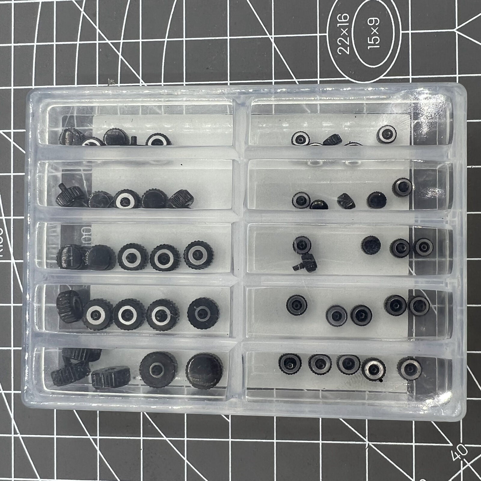 Assortment of 50 black waterproof stainless steel watch crowns for watch repairs.