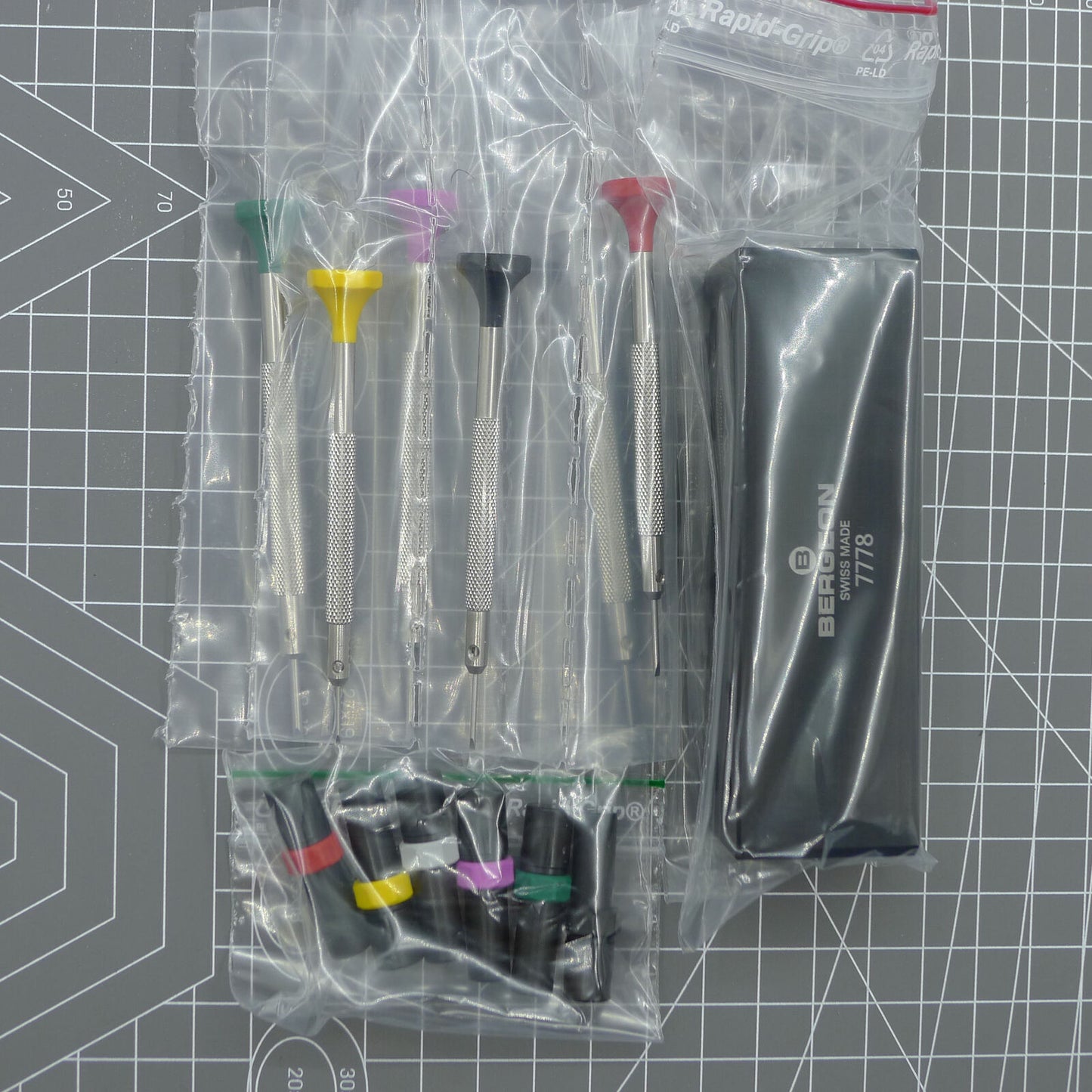Swiss Bergeon 7778 watch screwdriver set with 6 precision blades, spare tips, and organizer stand for watch repair.