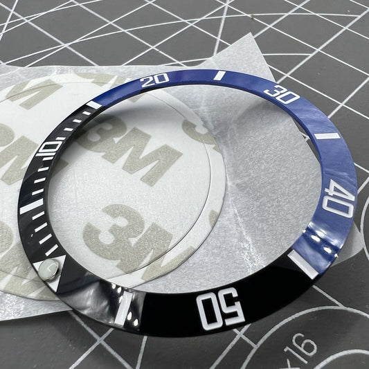 38mm Ceramic black and blue bezel with green lume and silver font for watch customization.