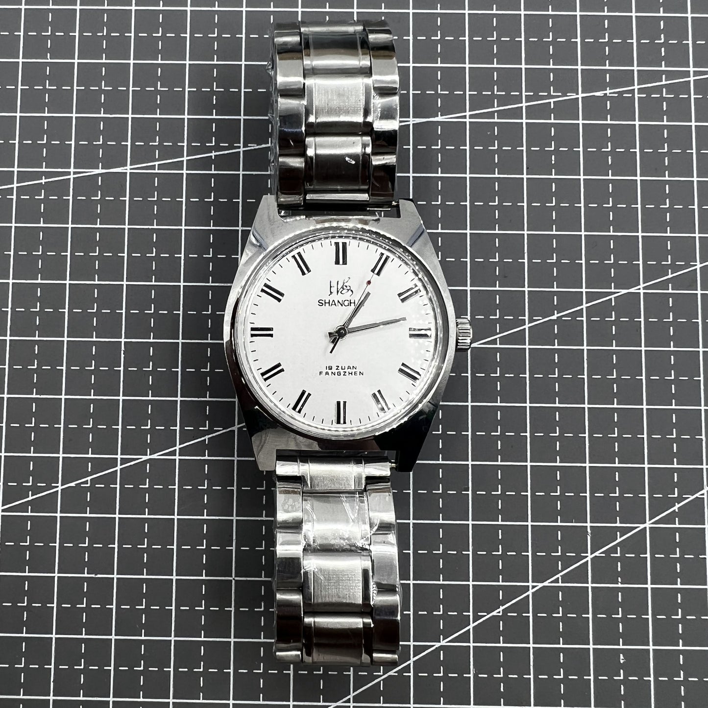 Shanghai 38mm manual mechanical watch with white dial, three hands, and stainless steel case by Shanghai brand.