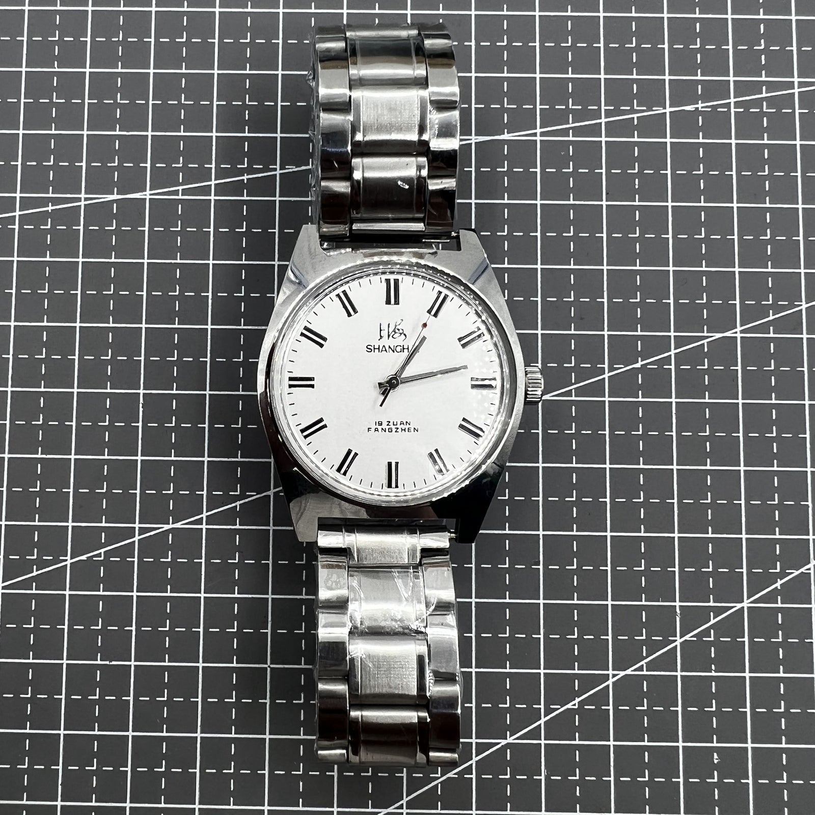 Shanghai 38mm manual mechanical watch with white dial, three hands, and stainless steel case by Shanghai brand.
