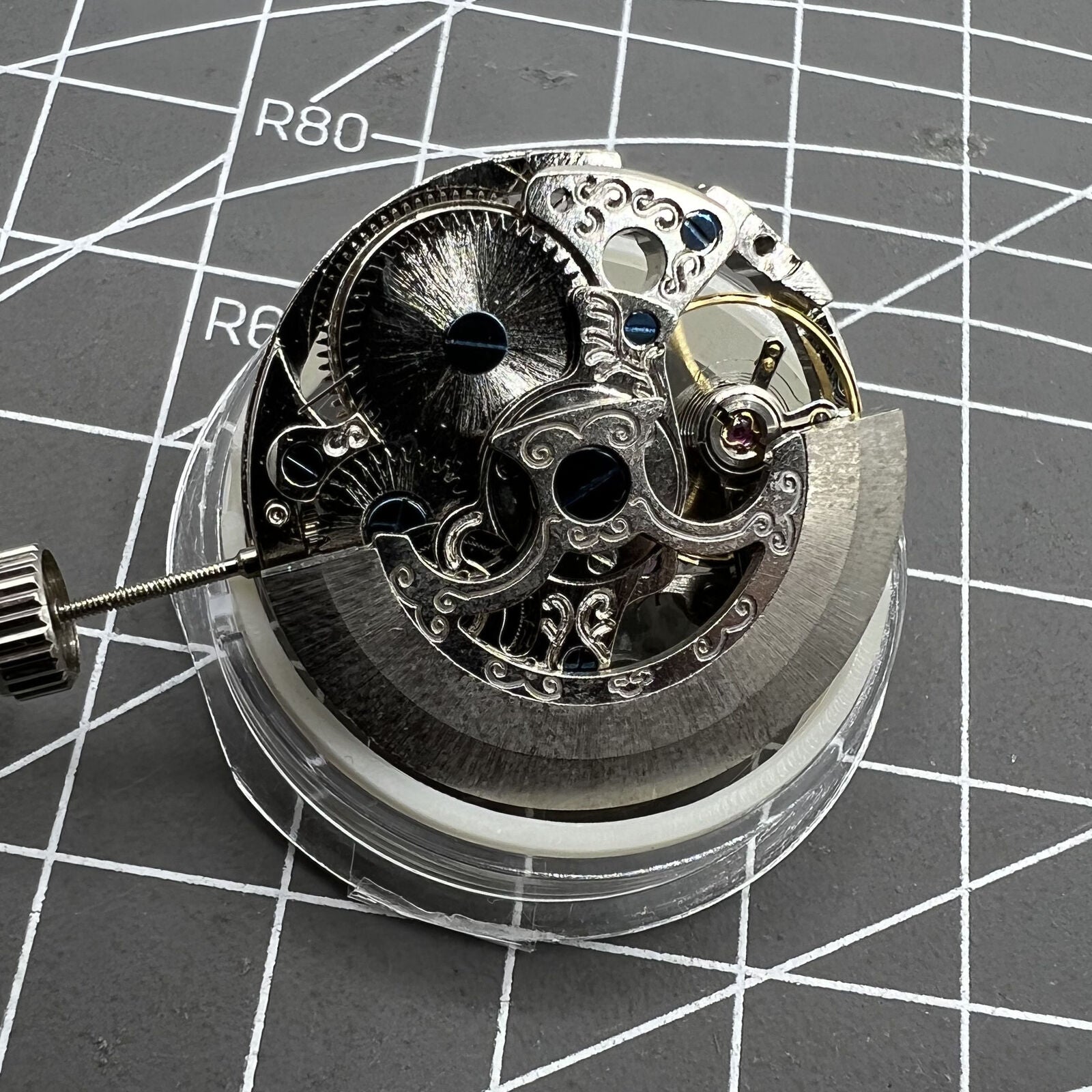 Carved Silver Hollow 7120 automatic watch with intricate mechanical movement and elegant design.