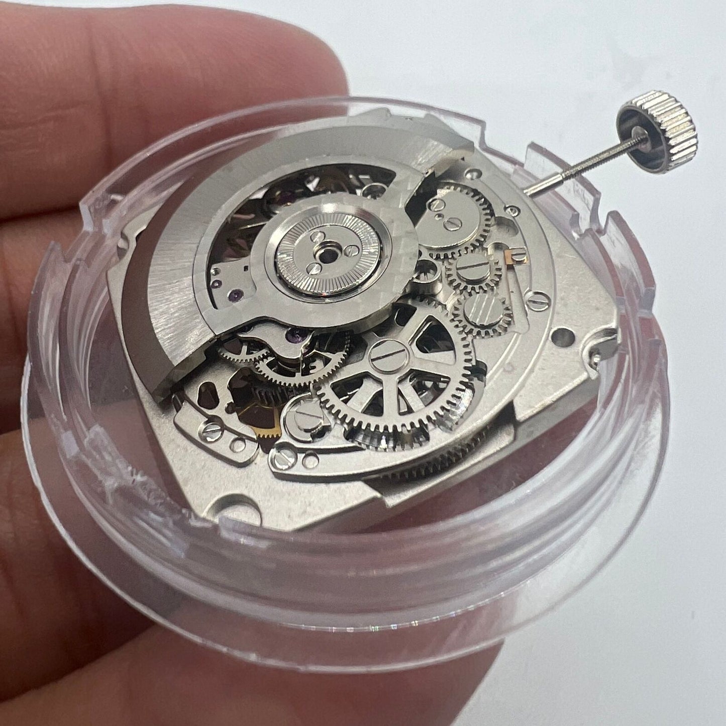 Tianjin Seagull ST25 silver square automatic watch movement with hollow design and three hands for precise timekeeping.