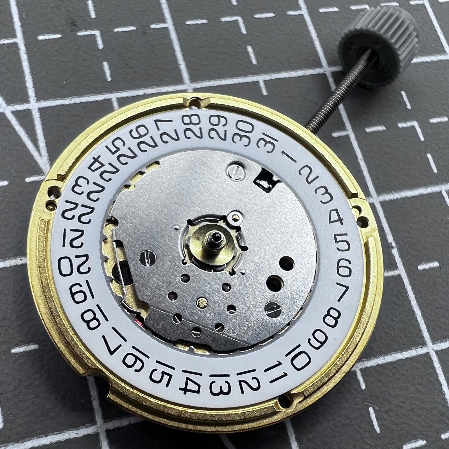 Swiss ETA F04.115 quartz watch movement with 3 hands and date display at 3 o'clock for precision timing.