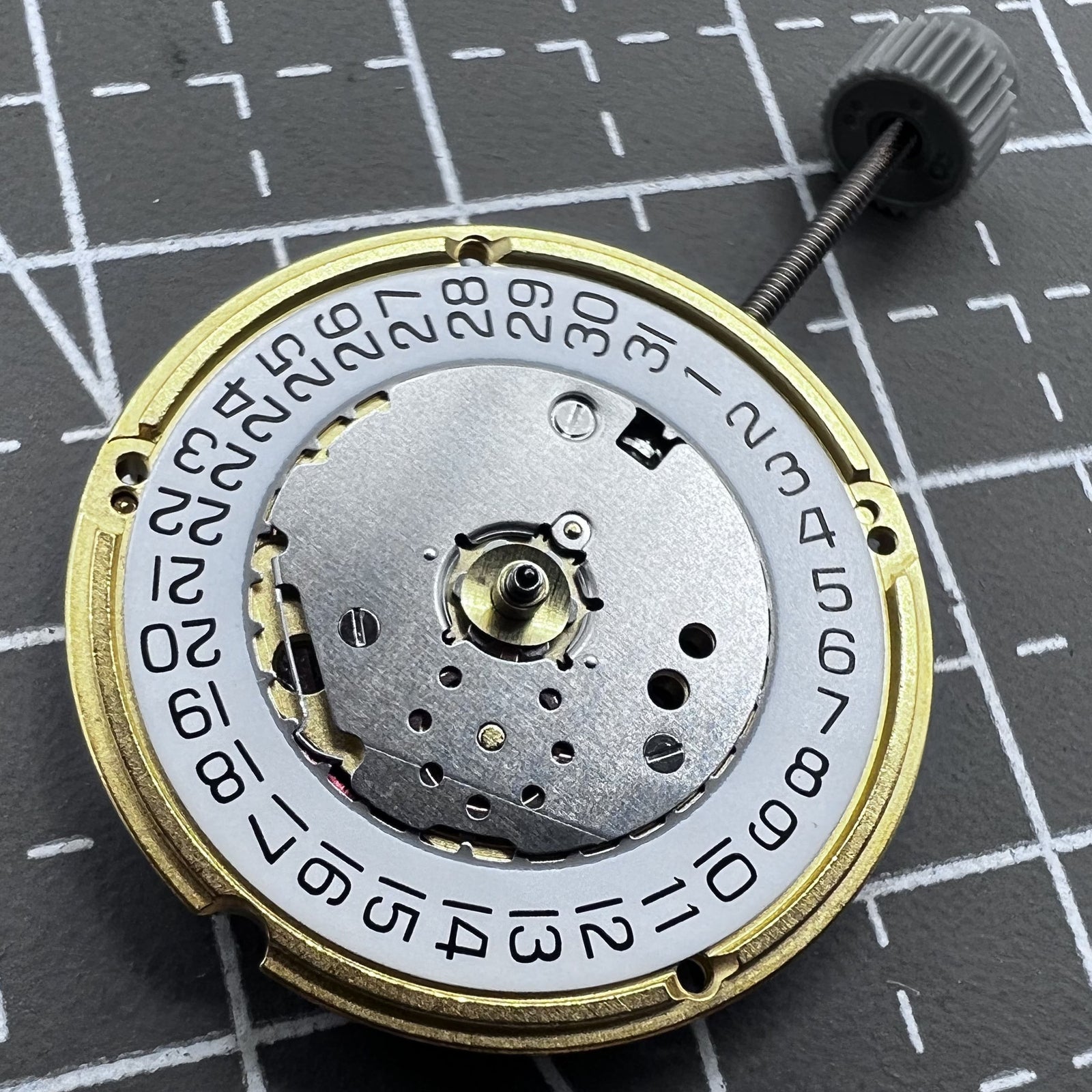 Swiss ETA F04.115 quartz watch movement with 3 hands and date display at 3 o'clock for precision timing.