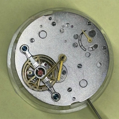 Shanghai brand watch accessory featuring mechanical movement with bare balance wheel and 6 o'clock flywheel detail.