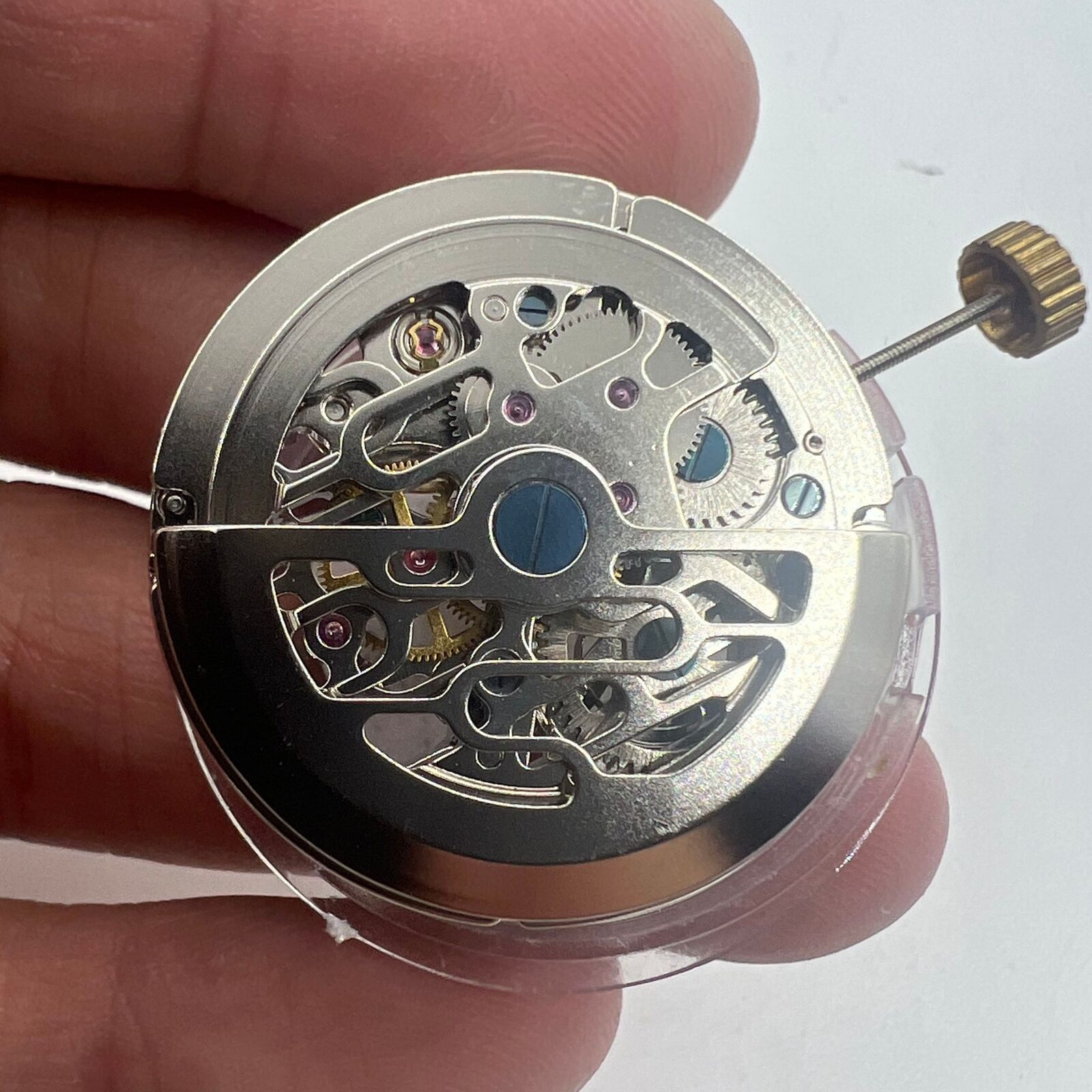 Dandong Hollow automatic watch with silver movement, small second hand at 9 o'clock, elegant design.