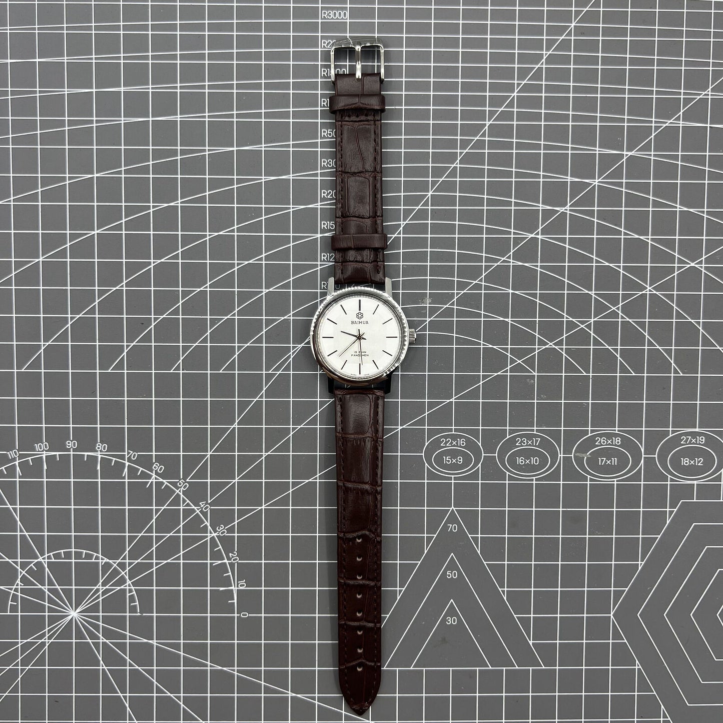 China Baihua 37mm manual mechanical watch with silver dial, 19 jewels, and shock-resistant design.