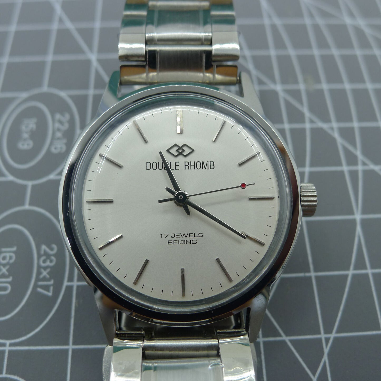 Beijing 36mm manual watch with silver case, nail-shaped markers, and classic elegant design by Beijing.