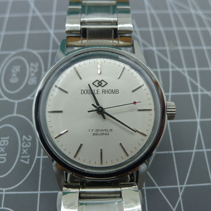 Beijing 36mm manual watch with silver case, nail-shaped markers, and classic elegant design by Beijing.
