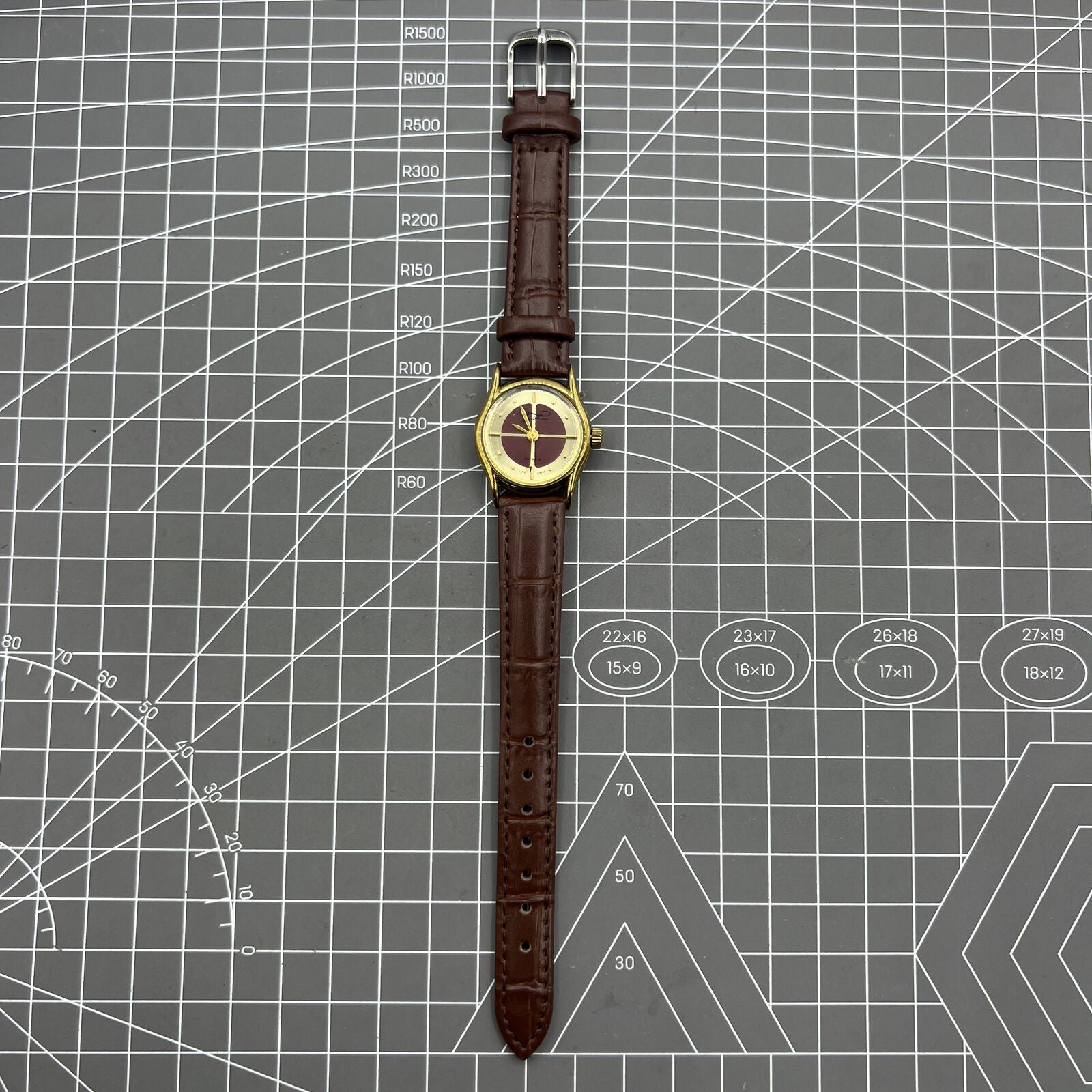 Brown 26mm Liaocheng TAISHAN manual mechanical lady watch with 19 jewels and golden nail details