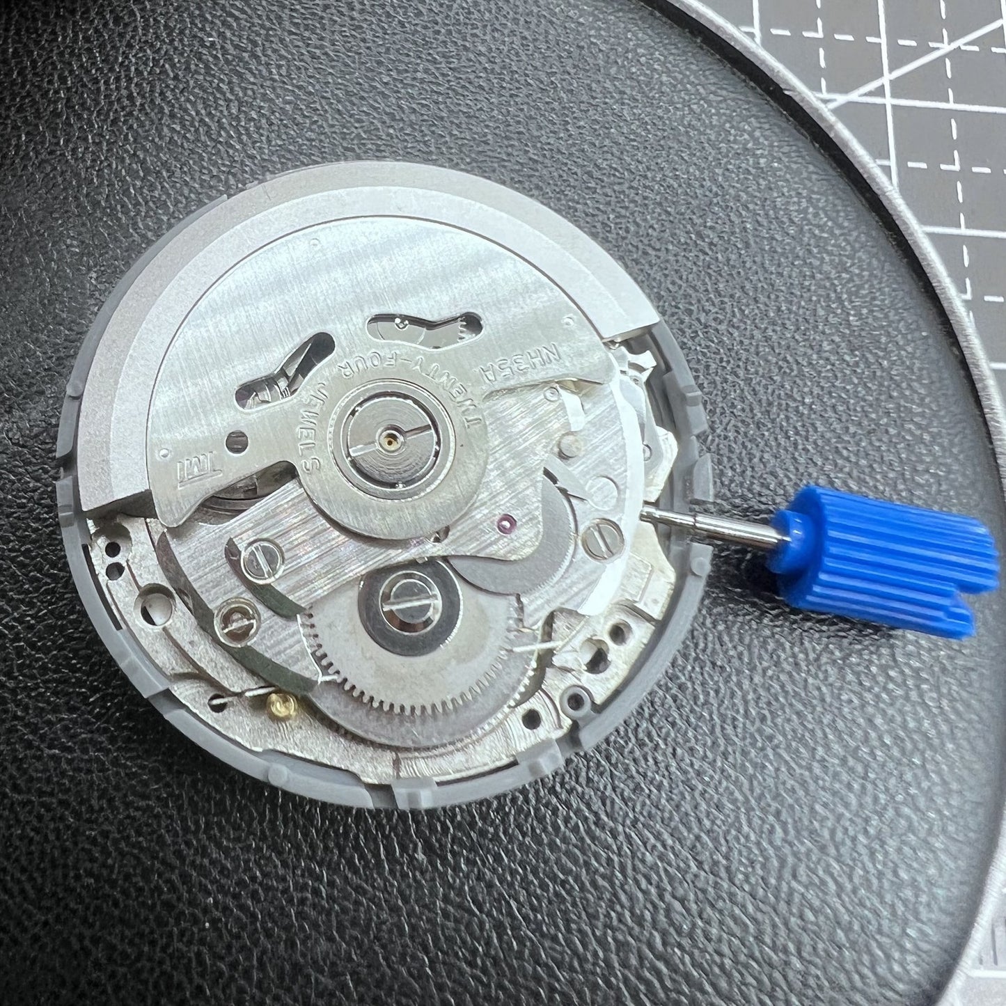 Seiko NH35 automatic watch movement with high precision and vibrant orange dial, ideal for watch repairs.