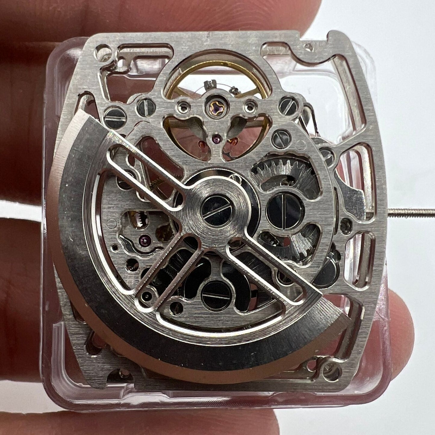 Asian HZ1C01A silver barrel-shaped watch accessory showcasing automatic mechanical movement details.