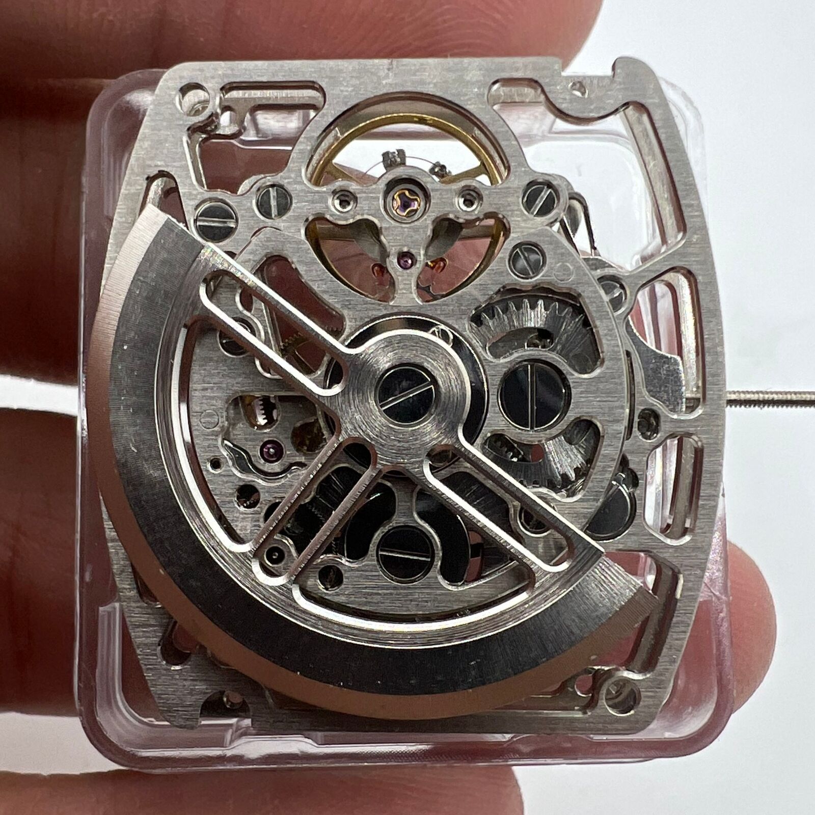 Asian HZ1C01A silver barrel-shaped watch accessory showcasing automatic mechanical movement details.