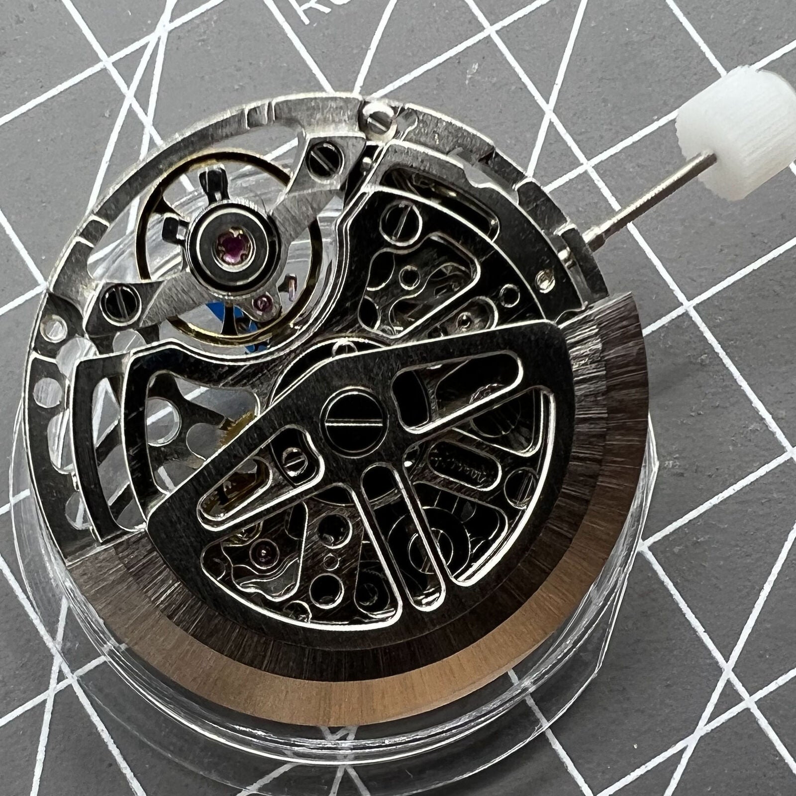 Asian HZ75DOA silver hollow balance wheel displaying precise automatic mechanical movement for watch enthusiasts.