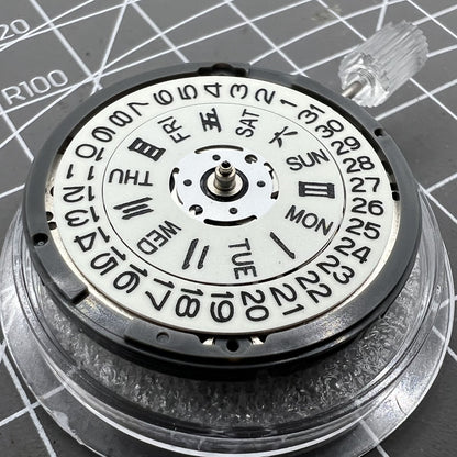 Miyota NH36A automatic watch movement with white dial, blue lume, and triple crown positions for precision adjustments.
