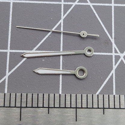 Silver arrow-shaped watch hands with trim, compatible with Miyota 2315 and 2035 movements for precise timekeeping.