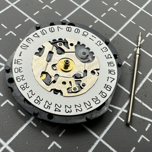 Hattori Epson VX12 quartz watch movement with date at 3, precision Japanese craftsmanship.