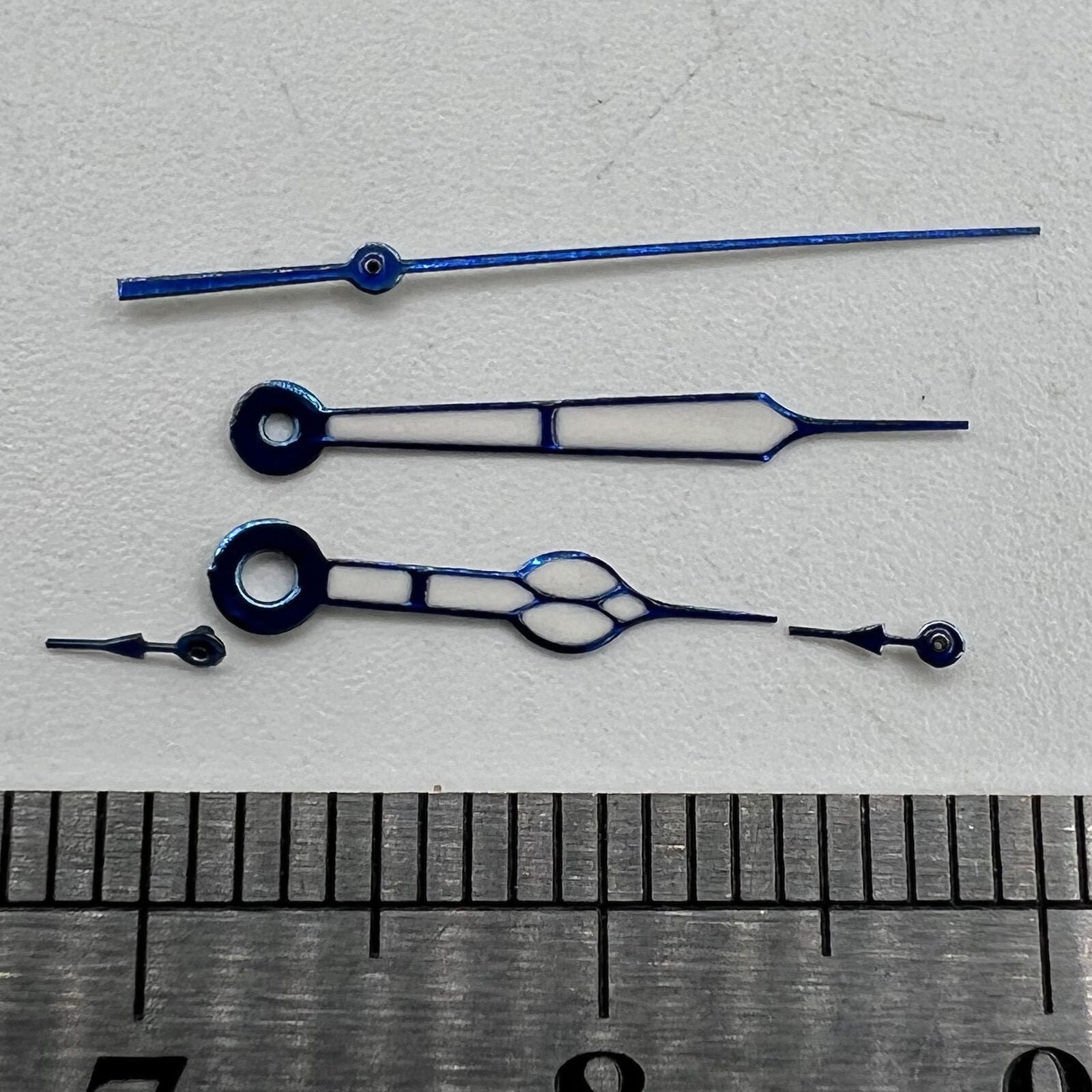 Blue trimmed watch hands with green lume for Miyota OS10 movement, precise fit and glow effect.