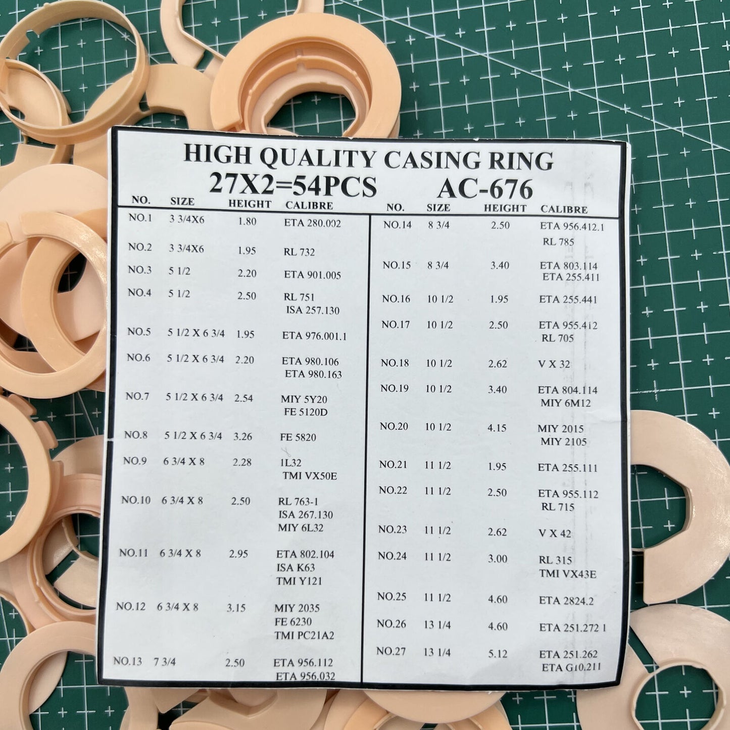 Set of 54 AC-676 watch movement case spacers, various 27 ligne sizes for precise watch repairs