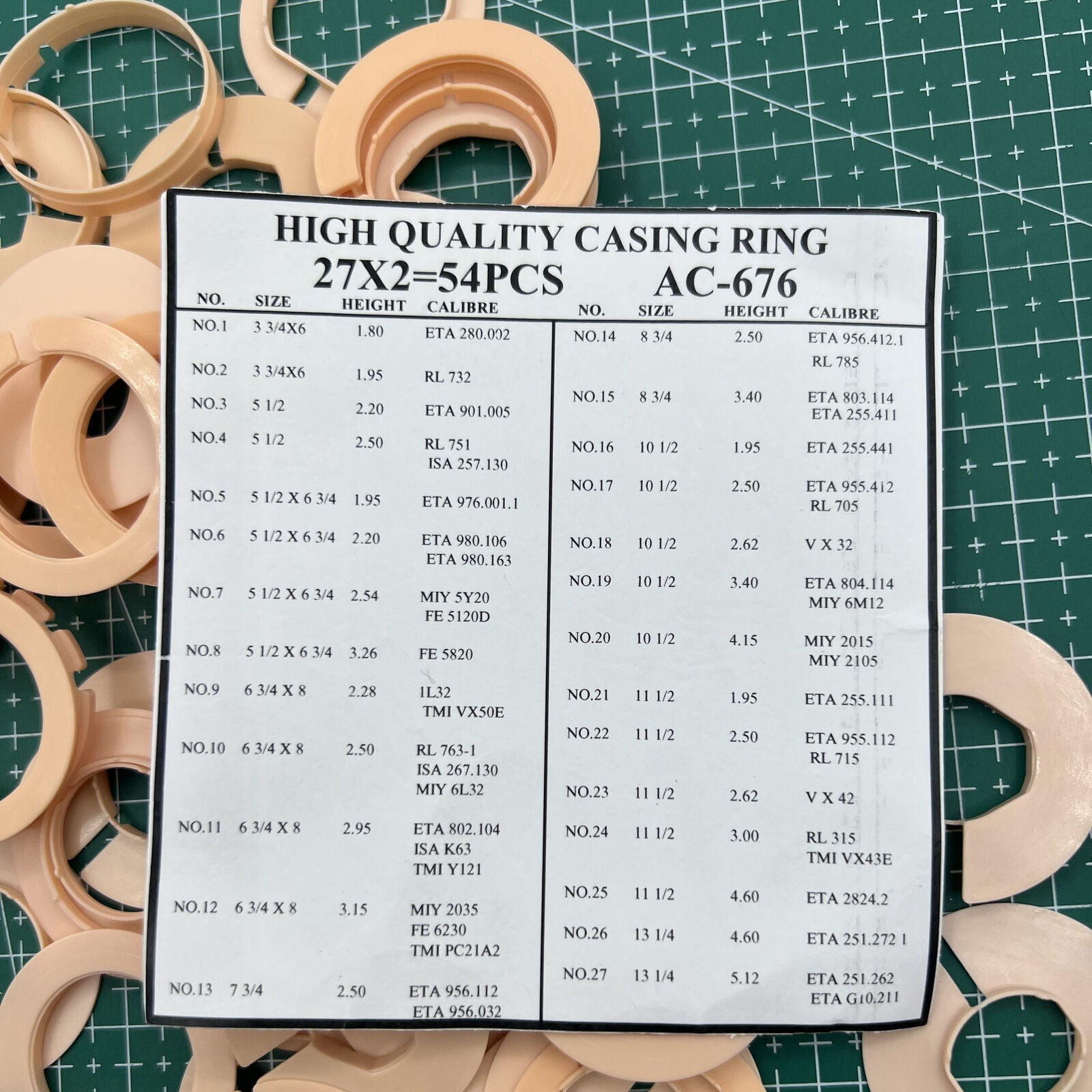 Set of 54 AC-676 watch movement case spacers, various 27 ligne sizes for precise watch repairs