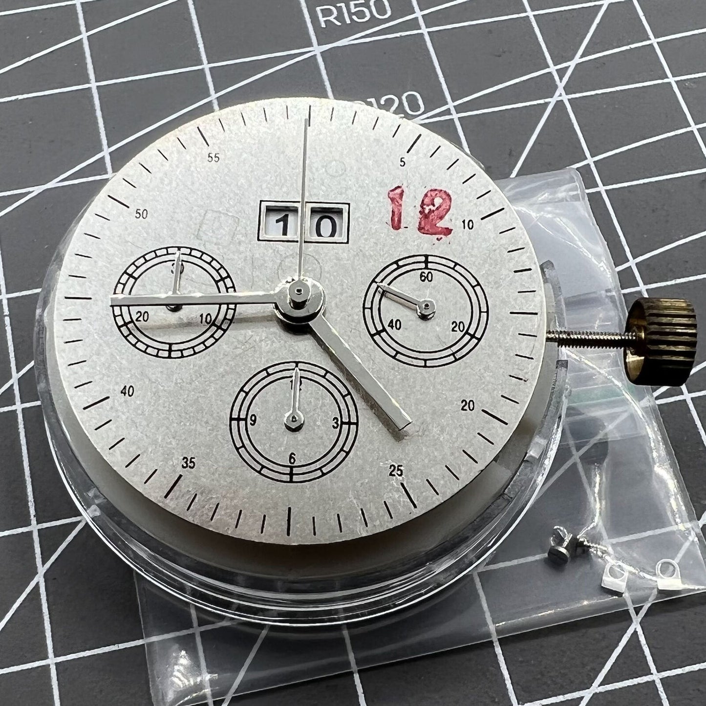 7750 mechanical watch movement featuring big date at 12 and small seconds at 3, showcasing precise craftsmanship.