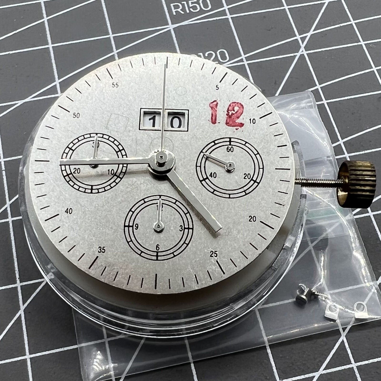 7750 mechanical watch movement featuring big date at 12 and small seconds at 3, showcasing precise craftsmanship.