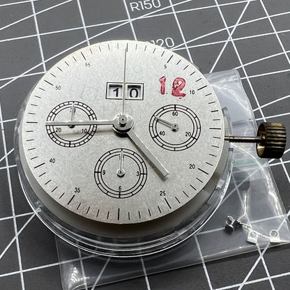 7750 mechanical watch movement featuring big date at 12 and small seconds at 3, showcasing precise craftsmanship.