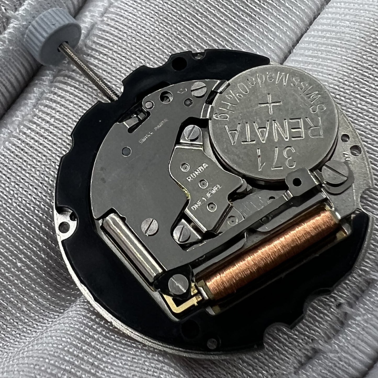 Swiss Made Ronda 705 quartz watch movement with date windows at 3 and 6 o'clock, accurate timekeeping.