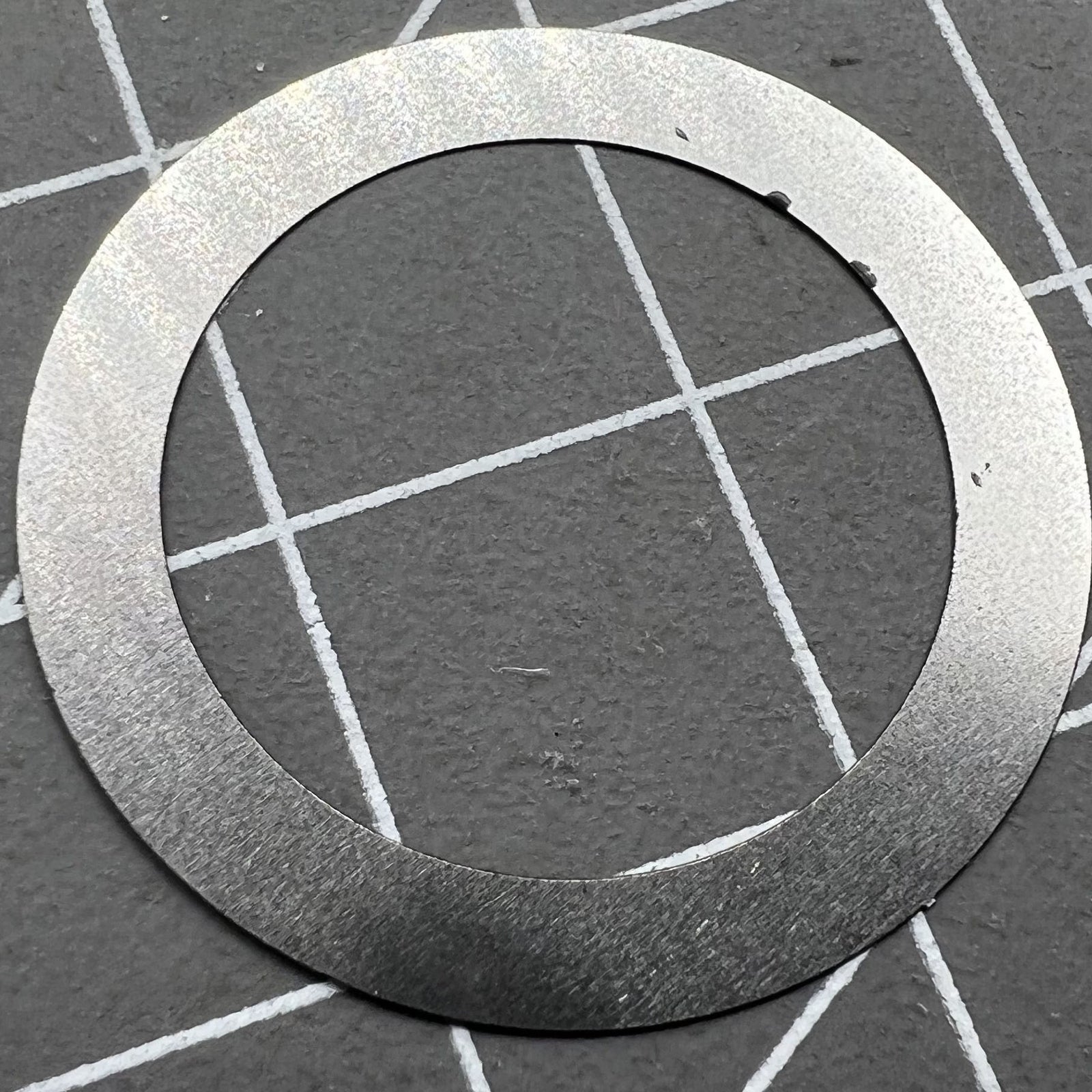 Close-up of Grey Character Date Disk for Seiko NH35 NH36 watch movement on black background.