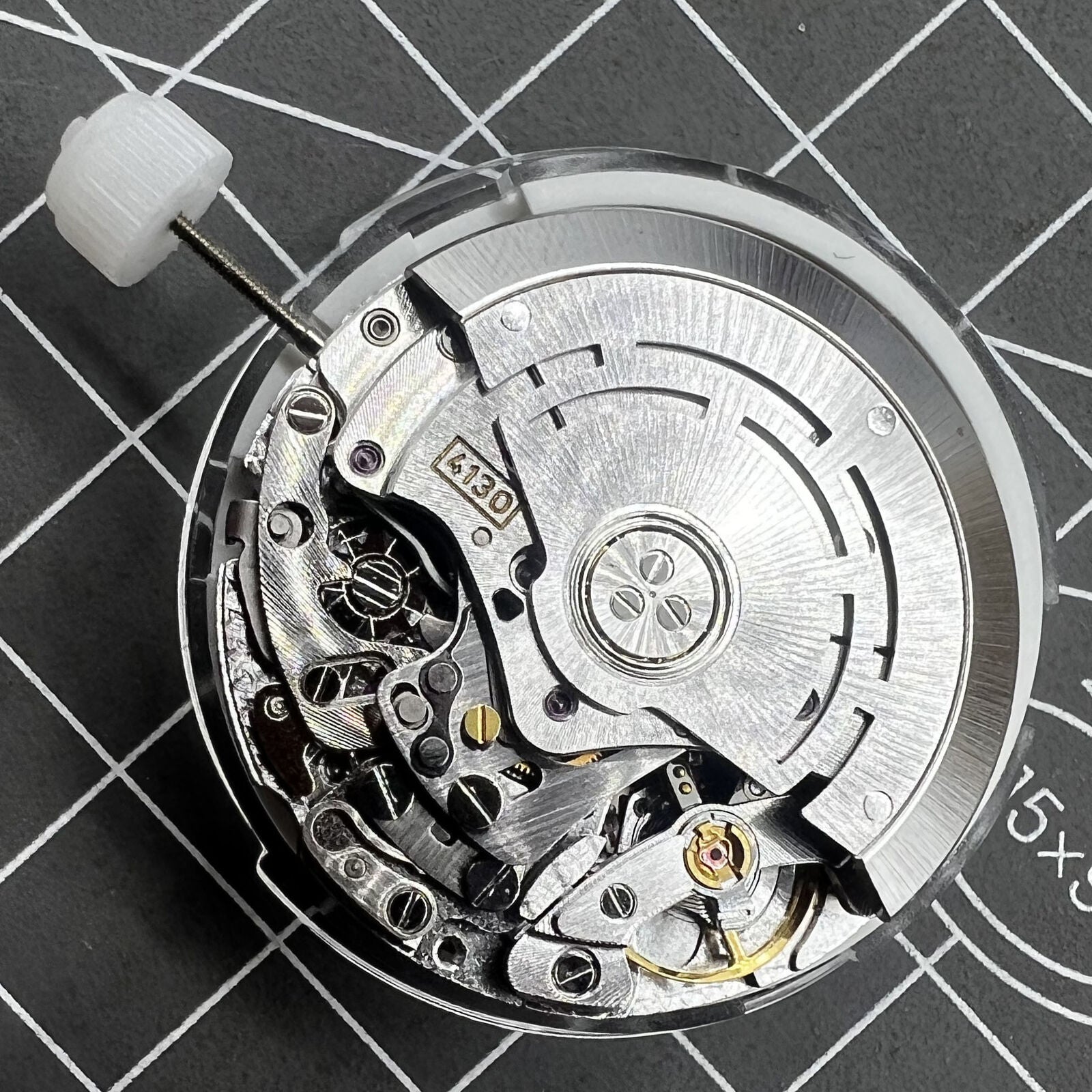 Chinese 4130 automatic watch movement with multifunctional small seconds at 3, 6, and 9 o'clock for precise timekeeping.
