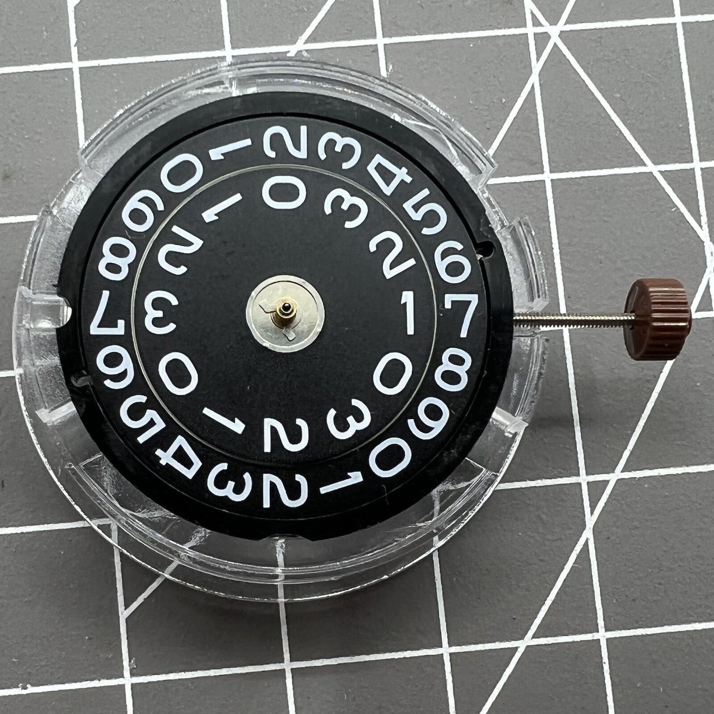 Swiss Ronda 509 quartz watch movement with black disk date at 3, precise timing for accessories.
