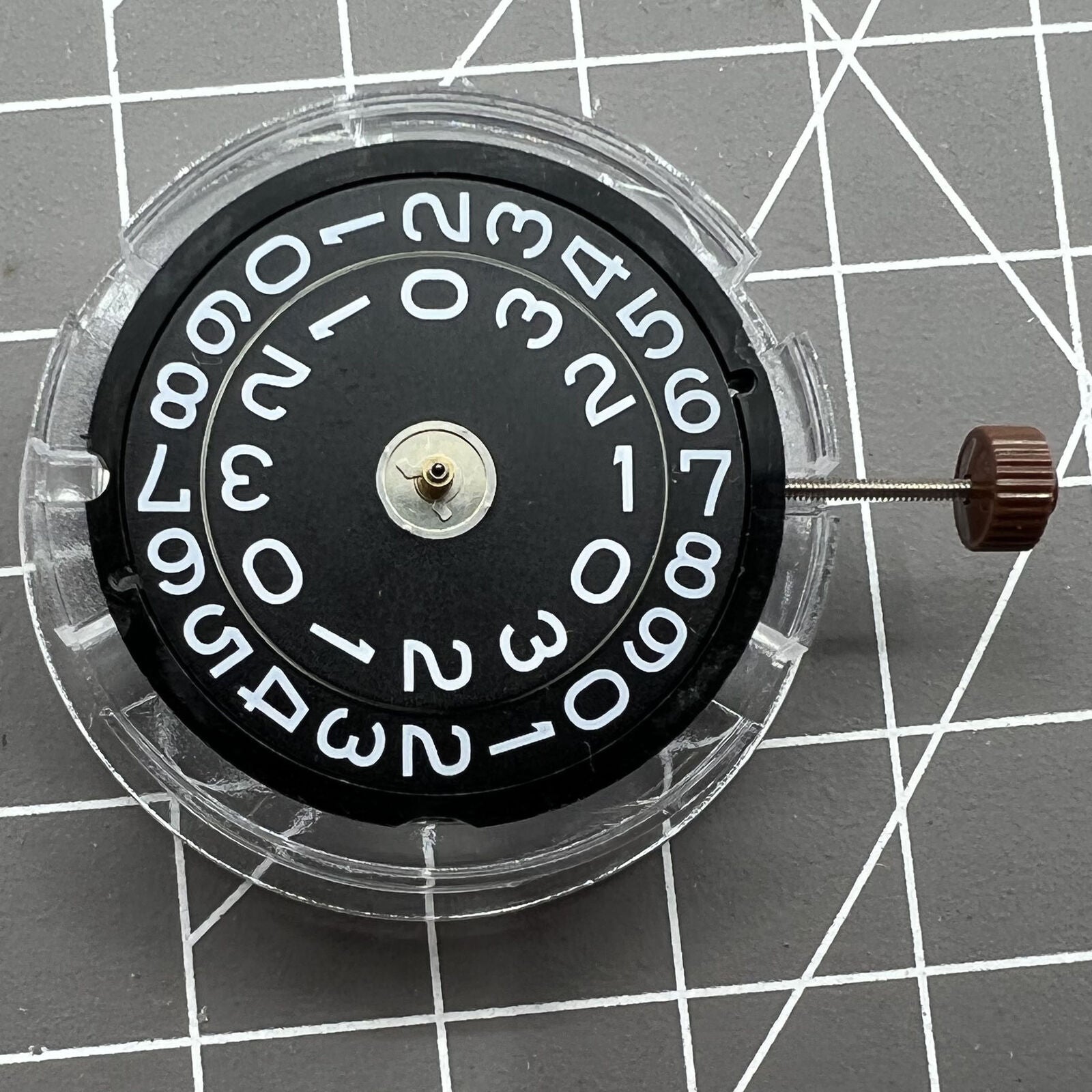 Swiss Ronda 509 quartz watch movement with black disk date at 3, precise timing for accessories.