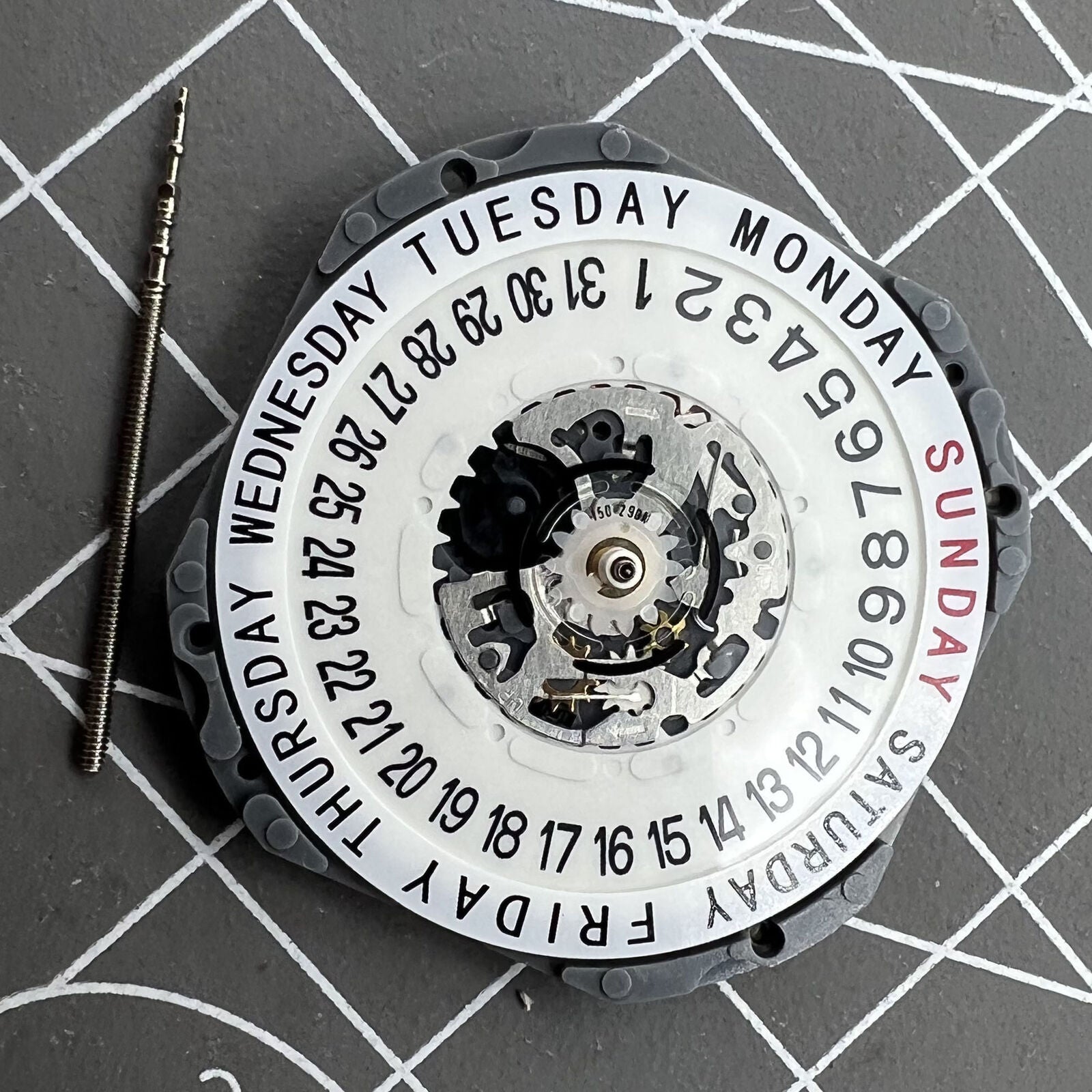 Hattori Epson TMI VJ55 quartz watch movement with date at 6, precision Japan-made component.