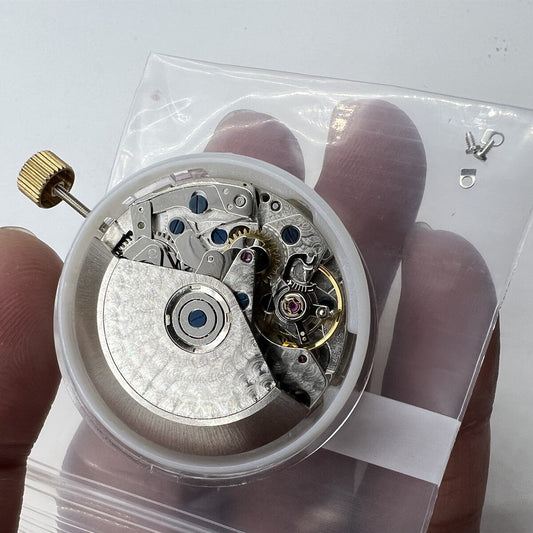 Black Dandong 7753 automatic watch with mechanical movement and small seconds at 9, China made.