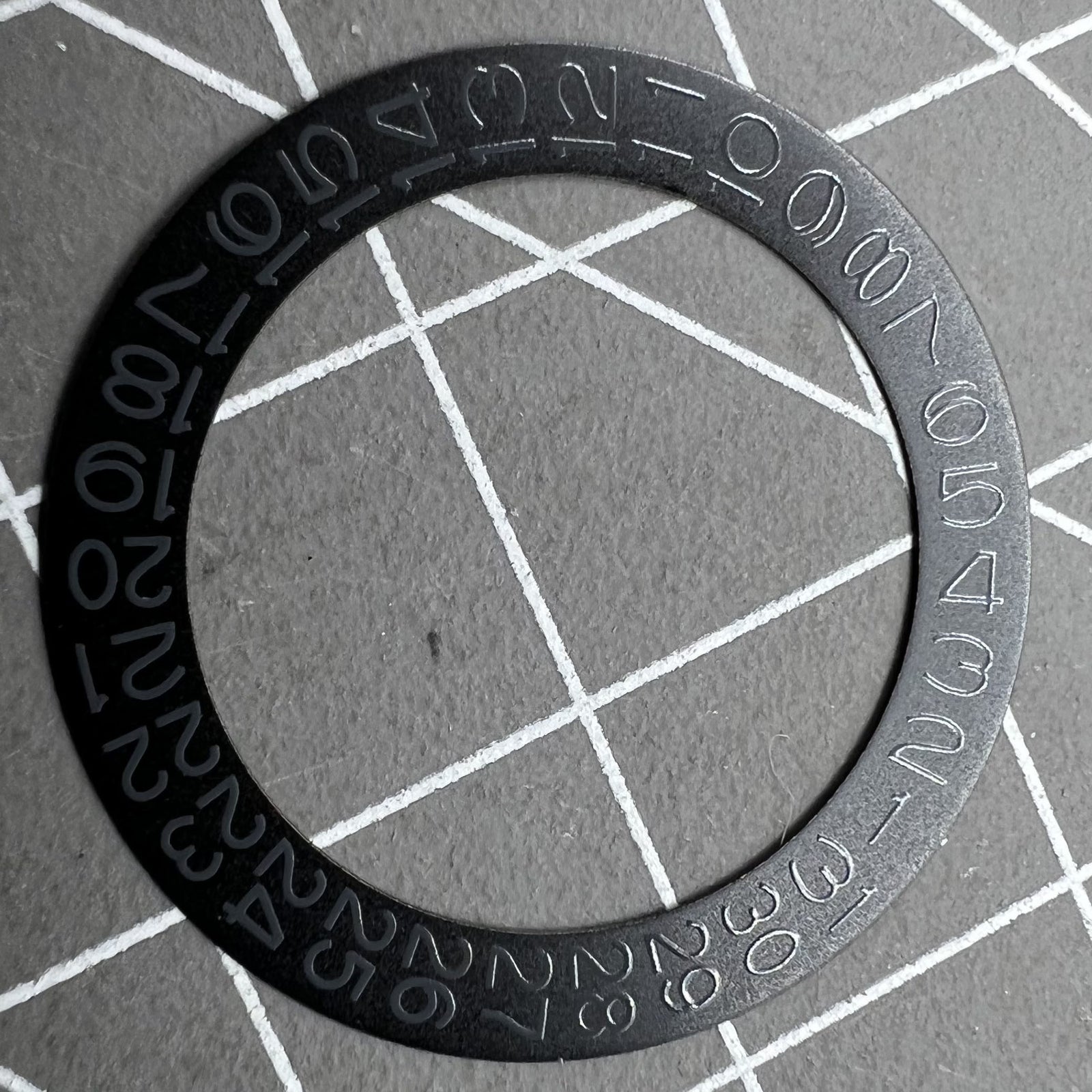 Black background close-up of Grey Character Date Disk for Seiko NH35 NH36 watch movement.