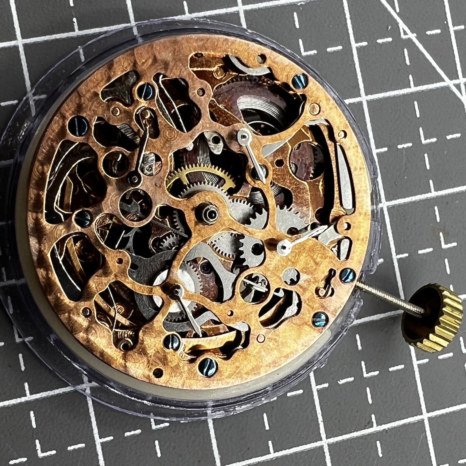 Hollow rose gold watch featuring mechanical movement, 4 subdials, and 7 hands for precise timekeeping.