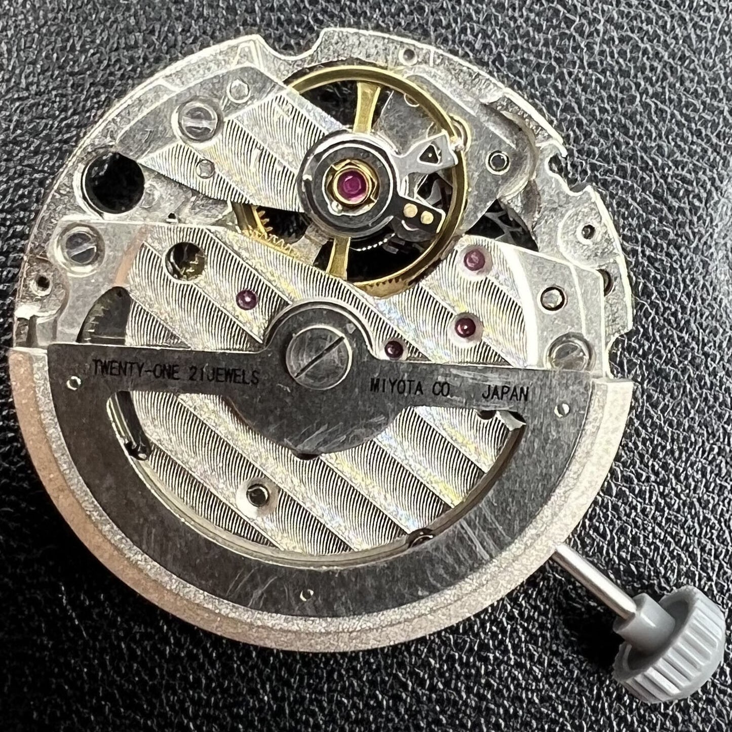 Miyota/Citizen 82S7 silver plated automatic watch movement showcasing precise mechanical engineering.