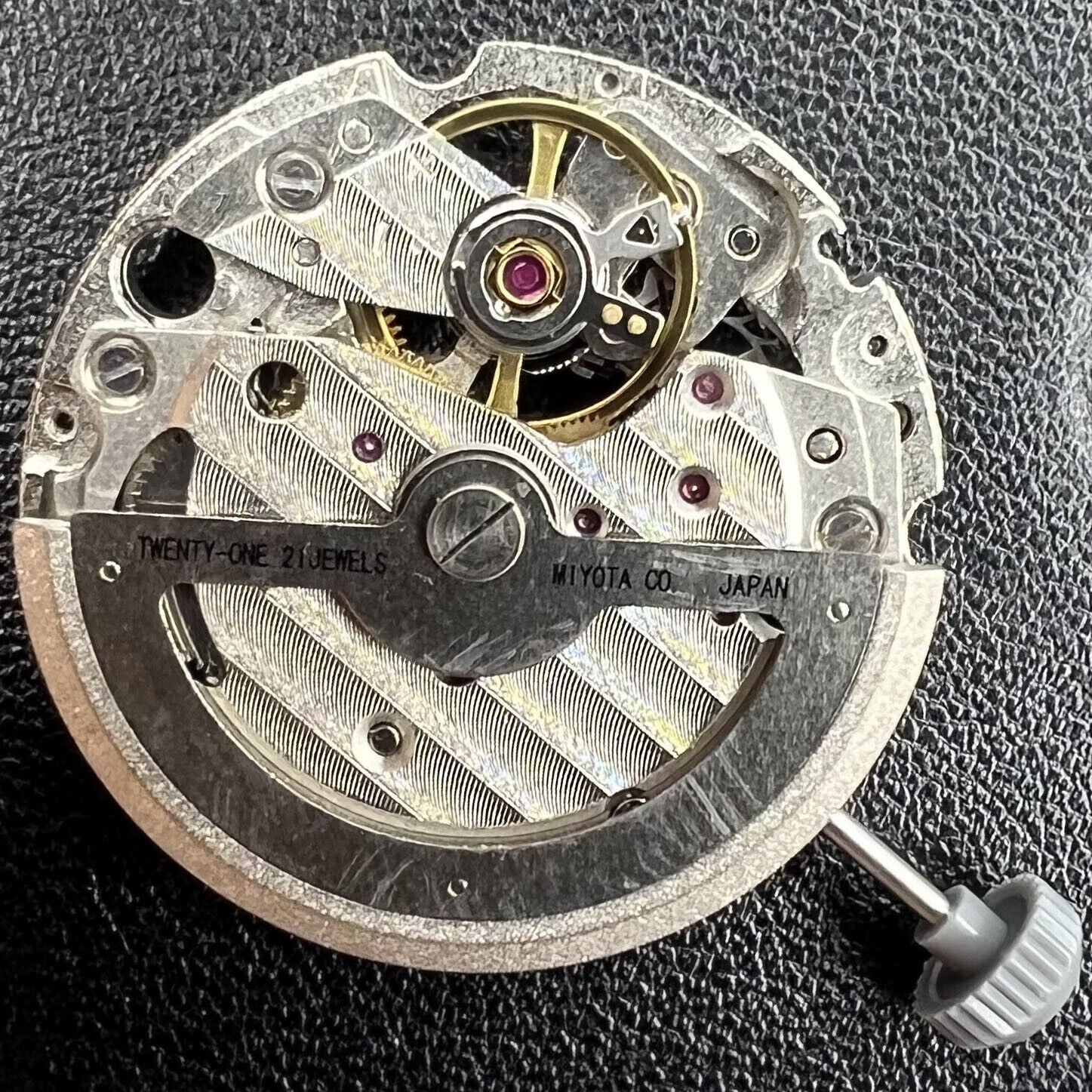 Miyota/Citizen 82S7 silver plated automatic watch movement showcasing precise mechanical engineering.