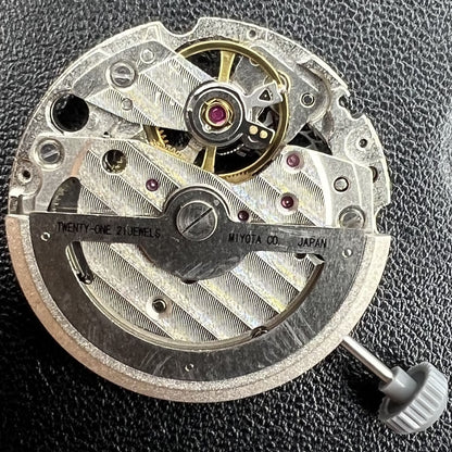 Miyota/Citizen 82S7 silver plated automatic watch movement showcasing precise mechanical engineering.