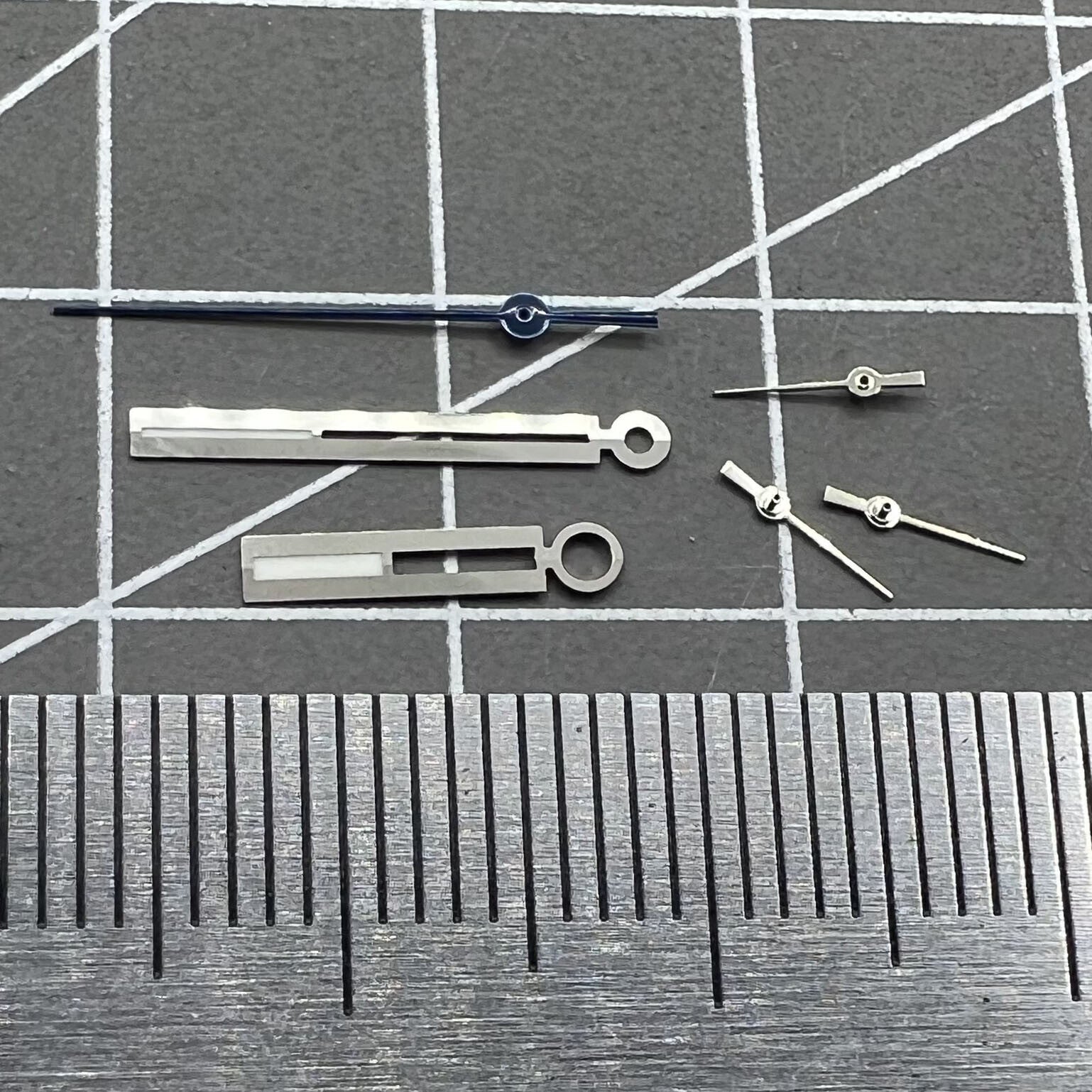 Luminous silver watch hands for Ronda 5021D quartz, perfect for accurate watch repair and upgrades.