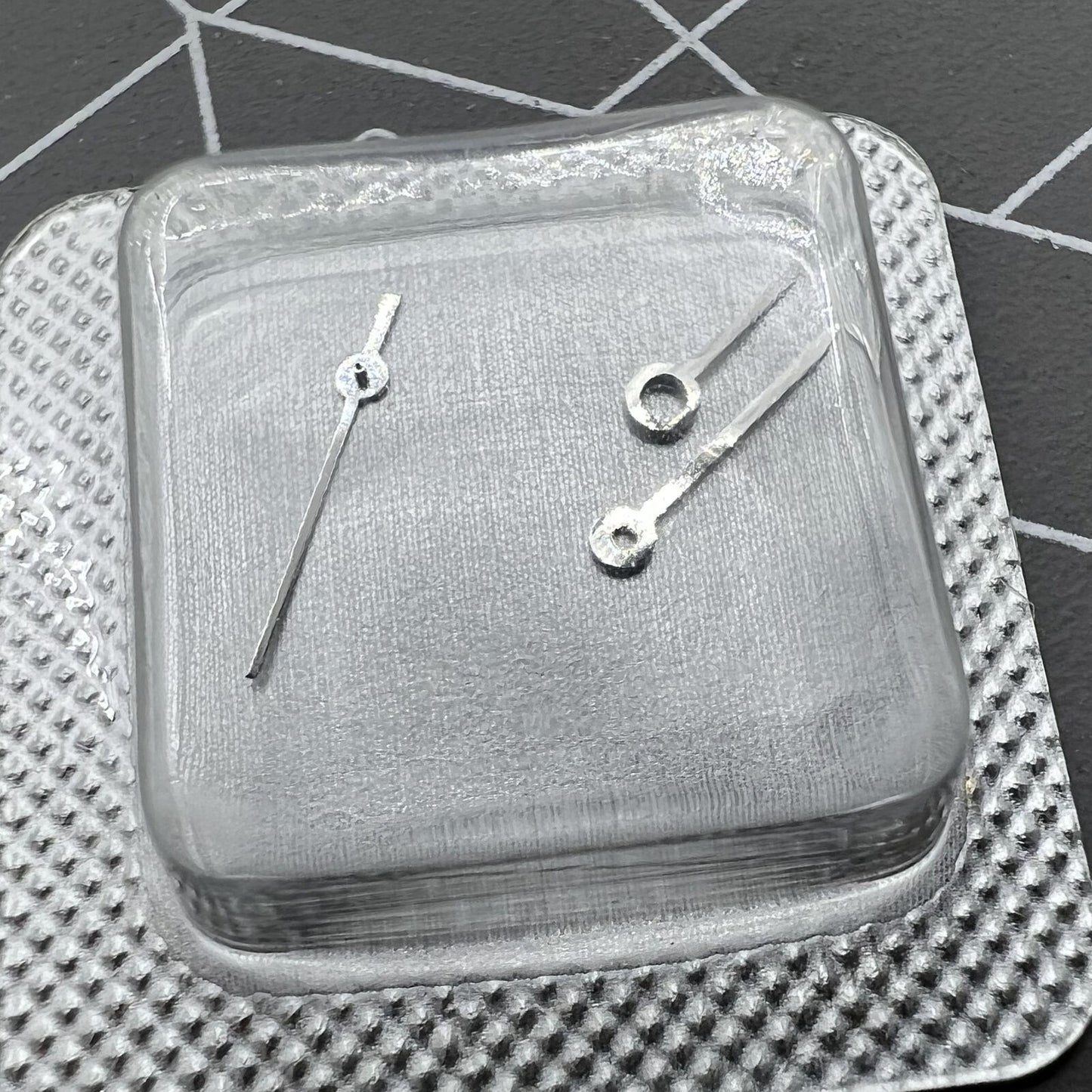 Silver watch hands set for ETA 956.112 movement, including hour, minute, and second hands.