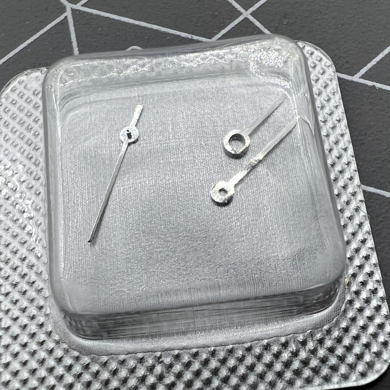 Silver watch hands set for ETA 956.112 movement, including hour, minute, and second hands.