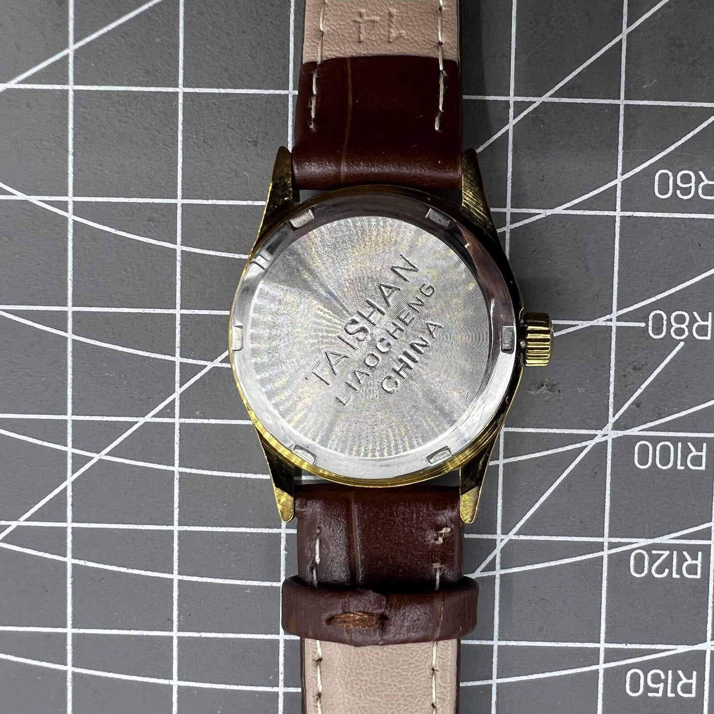 Brown 26mm Liaocheng TAISHAN lady watch featuring manual mechanical movement, 19 jewels, and gold nail accents.